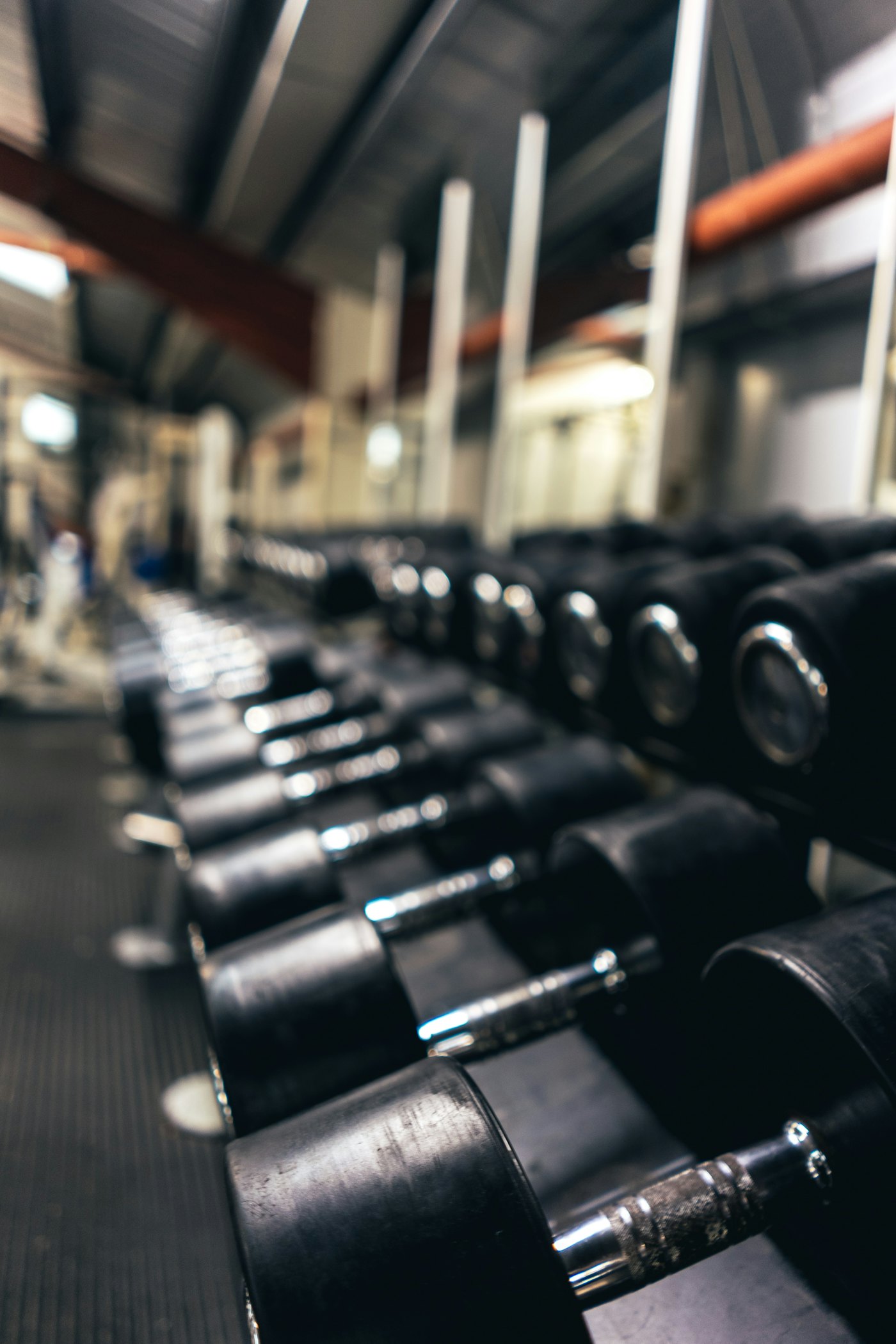 A long row of black dumbbells
